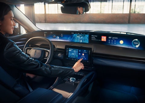 The driver of a 2024 Lincoln Nautilus® SUV interacts with the center touchscreen. | Eau Claire Lincoln in Eau Claire WI