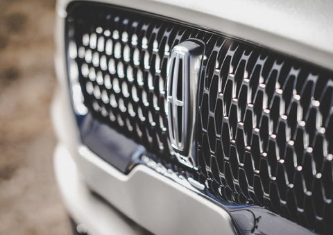 The grille of the 2024 Lincoln Aviator® Reserve model with an eye-catching repeated field of Lincoln Star logo shapes | Eau Claire Lincoln in Eau Claire WI