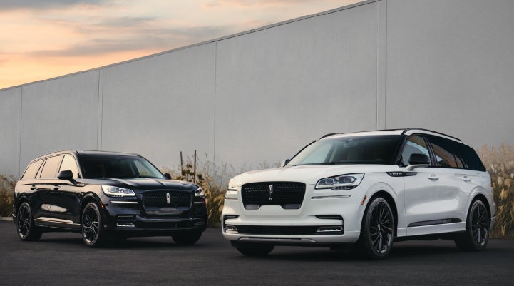 Two Lincoln Aviator® SUVs are shown with the available Jet Appearance Package | Eau Claire Lincoln in Eau Claire WI