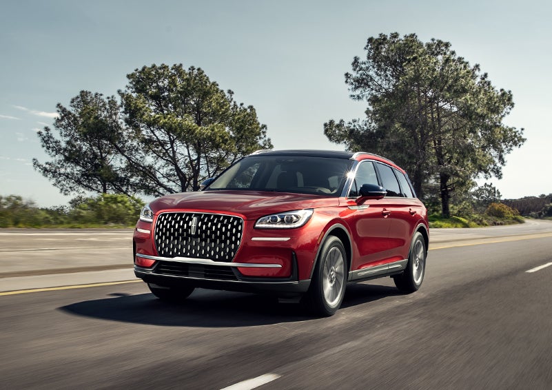 A 2024 Lincoln Corsair® SUV is shown being driven on a country road. | Eau Claire Lincoln in Eau Claire WI