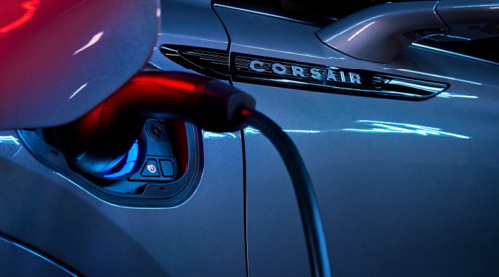 A charger plugged into the charging port of a 2024 Lincoln Corsair® Plug-in Hybrid model. | Eau Claire Lincoln in Eau Claire WI