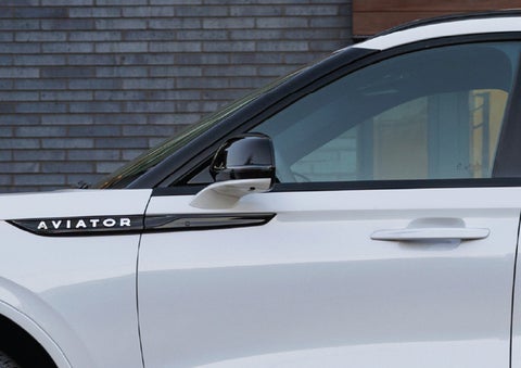 The driver’s side door and fender badging of a white 2026 Lincoln Aviator® SUV are showcased. | Eau Claire Lincoln in Eau Claire WI