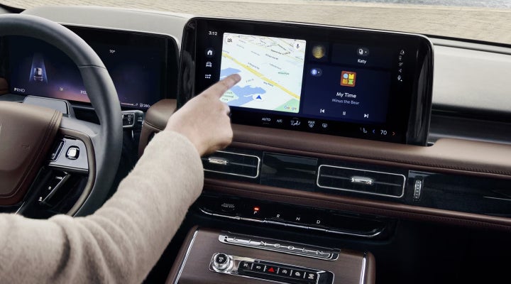 A person is tapping the center display touchscreen of a 2026 Lincoln Aviator® SUV. | Eau Claire Lincoln in Eau Claire WI