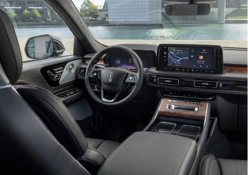 The interior of the 2026 Lincoln Aviator® SUV is shown parked with a view of a harbor through the windshield. | Eau Claire Lincoln in Eau Claire WI