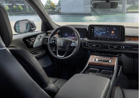 The interior of the 2026 Lincoln Aviator® SUV is shown parked with a view of a harbor through the windshield. | Eau Claire Lincoln in Eau Claire WI