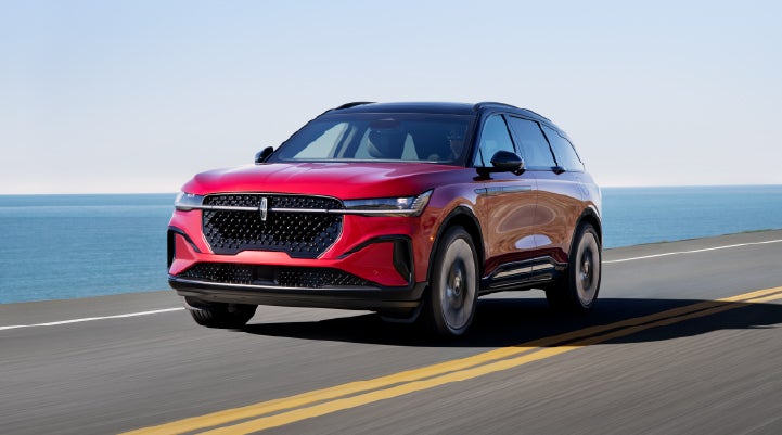 A 2026 Lincoln Nautilus® SUV is being driven on a seaside roadway. | Eau Claire Lincoln in Eau Claire WI