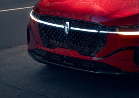 The available front LED light bar and center Lincoln Star logo glow at dusk. | Eau Claire Lincoln in Eau Claire WI