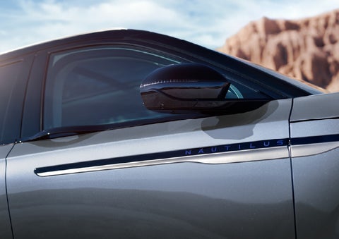 Blue lettering on the side of the vehicle that reads Nautilus indicates the available Hybrid Powertrain. | Eau Claire Lincoln in Eau Claire WI