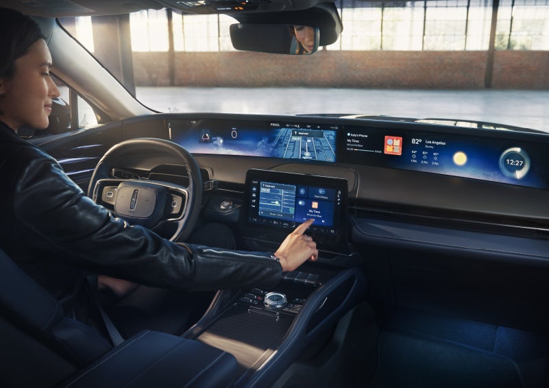 The driver of a 2026 Lincoln Nautilus® SUV interacts with the center touchscreen. | Eau Claire Lincoln in Eau Claire WI
